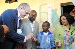 • (L-R) Merck CEO Dr Stefan Oschmann administers the drug on a student of LEA Primary School karon-majigi, watched keenly by one of the school teachers and Director public Health (FMOH) Dr Bridget Okoeguale. Health (FMOH) Dr Bridget Okoeguale during the handing over of drugs to the Federal Ministry of Health and children at Local Education at LEA School in Karon – majigi Abuja yesterday