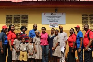 Officials of Save The Children, Reckitt Benckiser, Shomolu Local Govrrnment, teachers and pupils at the commissioning of one of the toilets 