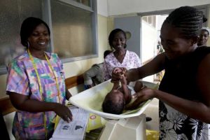 health-workers-weighing-baby